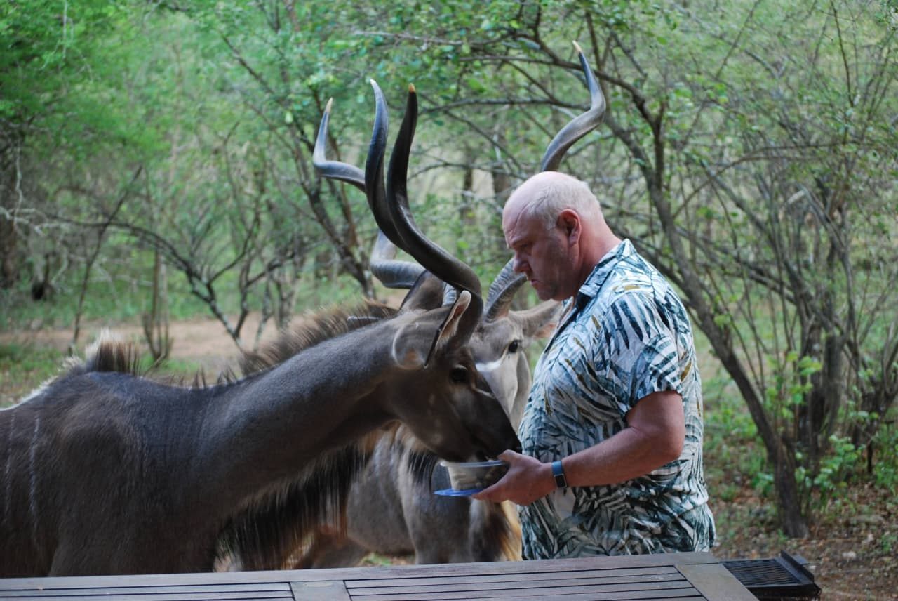 Nikolaus feeding a kudu in the bush